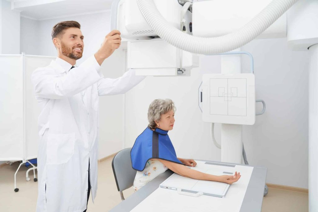 Radiologist regulating ultra sound tool preparing for diagnostic.