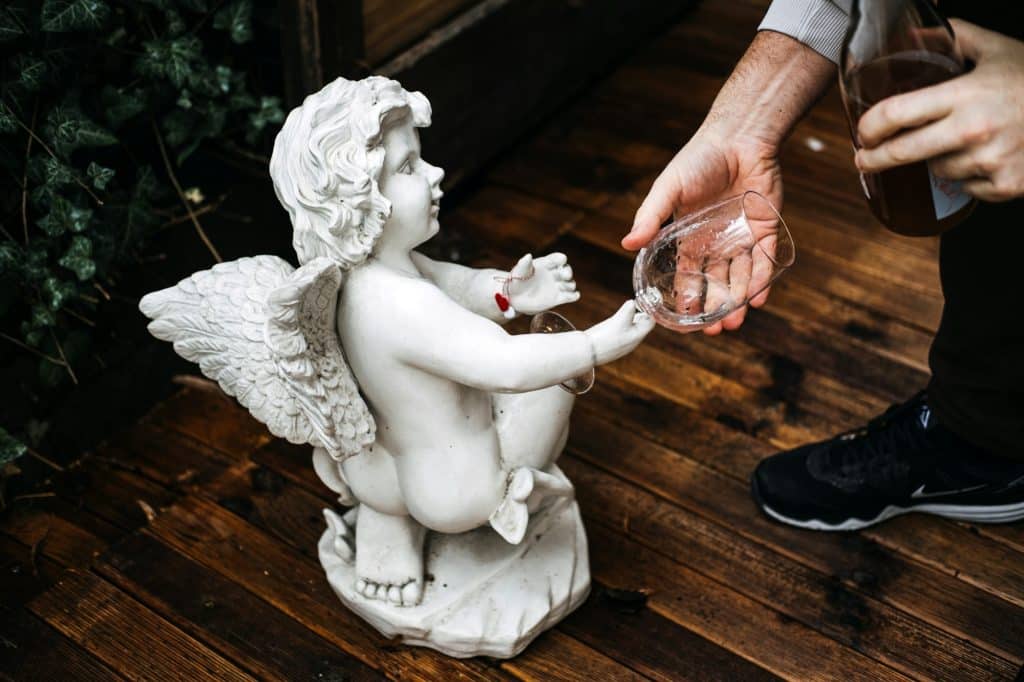 Cherub Statue Partakes in the Whimsy of Wine Culture