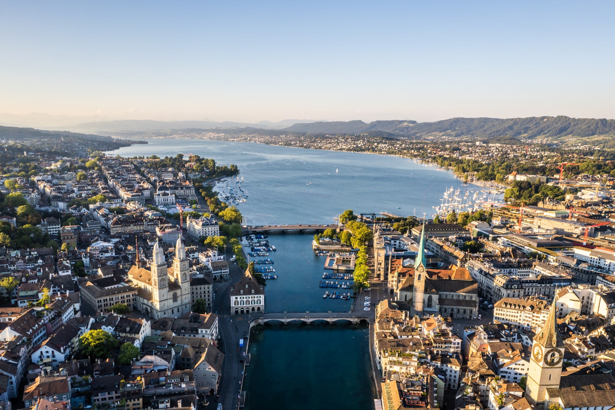 Aerial drone shot flying above Lake Zurich, Switzerland in sunny day.