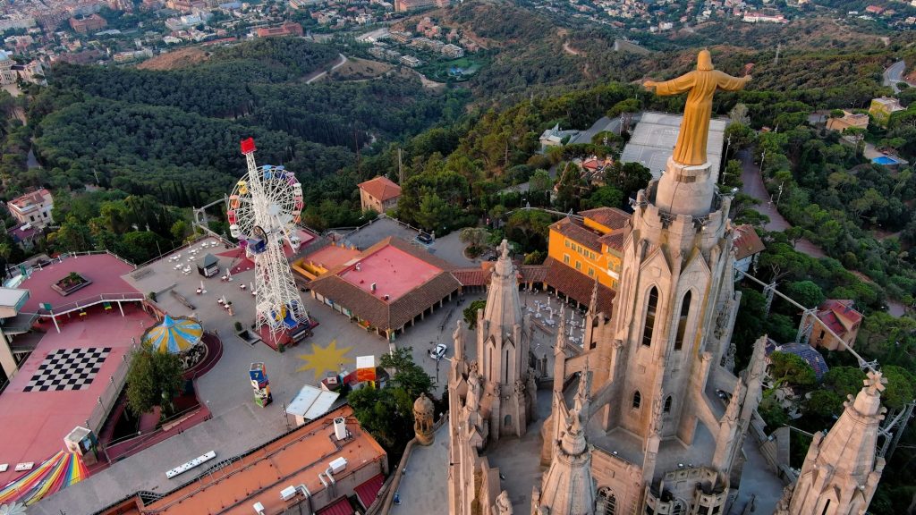 Aerial view of Tibidabo, Barcelona city skyline with Sagrat Cor temple at sunrise. Catalonia, Spain