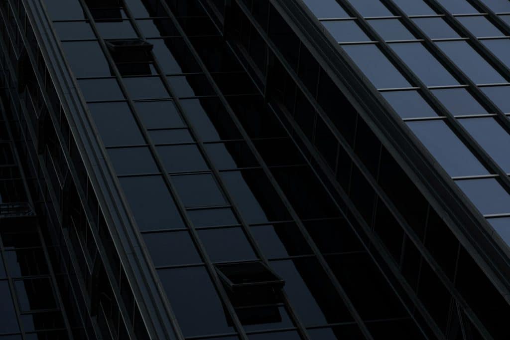 Black wall of building with opened windows